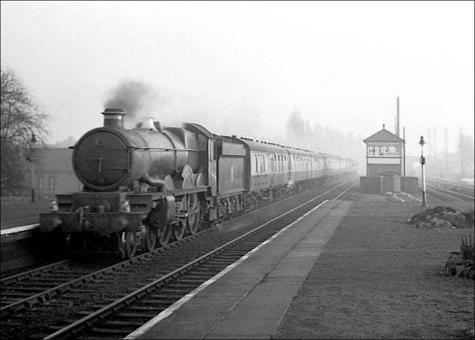 Ex-GWR 4-6-0 4073 Class No 5036 'Lyonshall Castle' passes through the station on a down express in June 1957