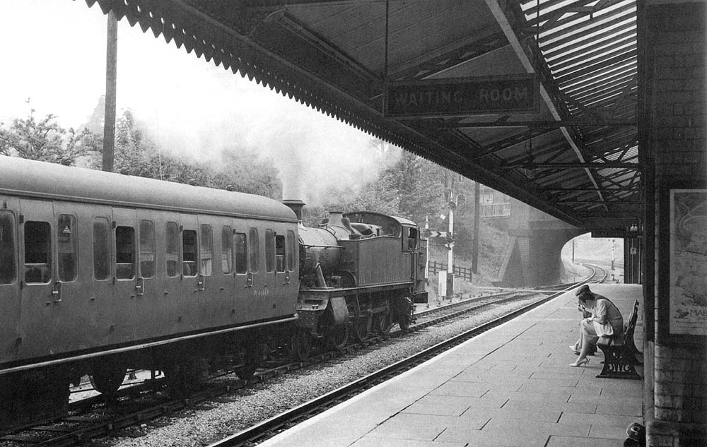 Ex-GWR 2-6-2T 5101 Class No 4114 restarts with an empty stock working from the station's goods loop line on 22nd July 1959