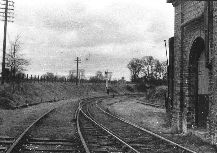 View from the junction with the MR showing the disused line towards Great Alne with the water tower adjacent to the abandoned shed on the right