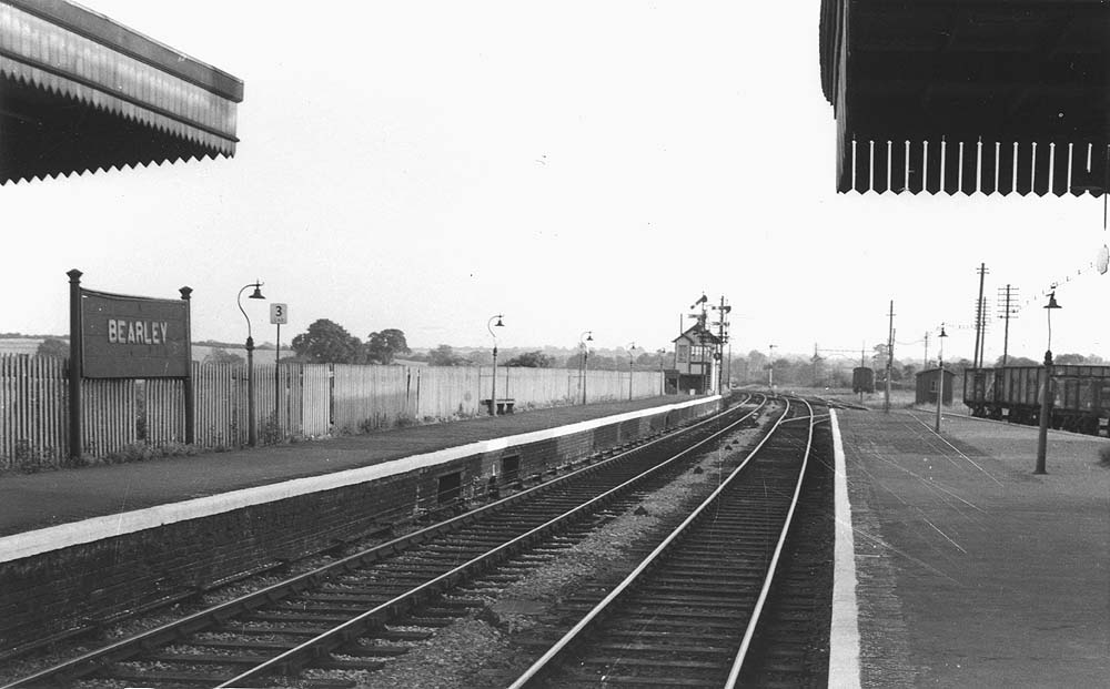 Looking along the rebuilt station's up platform towards a deserted goods yard and Bearley Junction in 1959