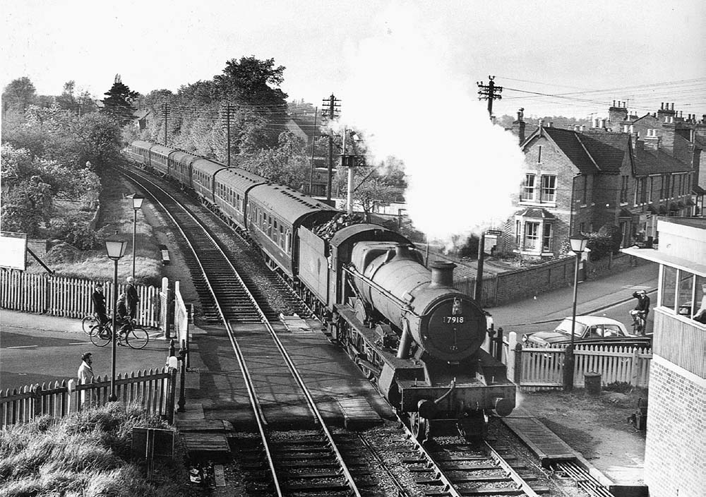 British Railways built 4-6-0 Modified Class No 7918 'Rhose Wood Hall' passes Evesham Road Crossing in May 1964