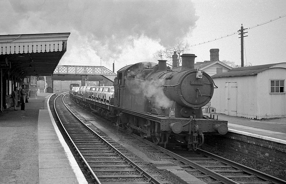 Ex-GWR 56xx Class 0-6-2T No 6697 is seen passing through Hatton with a BMC car train for the south on 7th May 1965