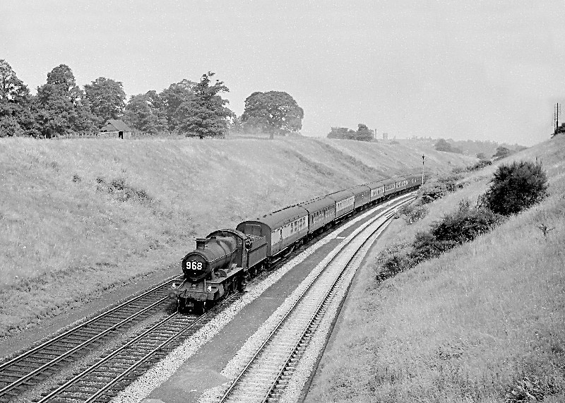 An unidentified ex-GWR 2-6-0 43xx class with a Northbound Express ascending Hatton Bank on the Down main line dated August 1959