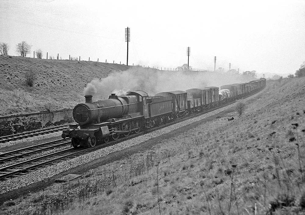 Ex-GWR 4-6-0 Grange Class No 6853 'Morehampton Grange' is seen running south on Hatton Bank with an up freight on 22nd April 1965