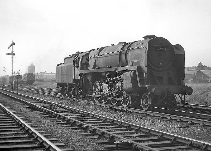 British Railways Standard Class 9F 2-10-0 No 92204 reverses into Queens Head sidings on 28th May 1964