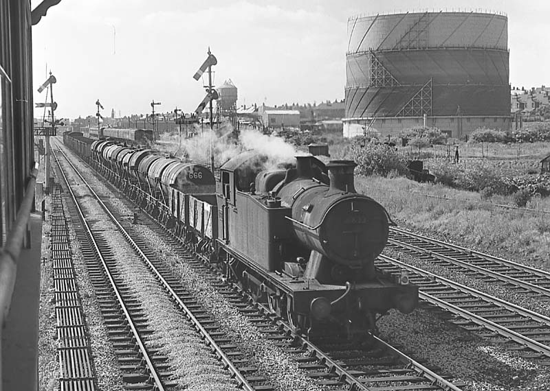 GWR 56xx Class 0-6-2T No 6633 heads an up freight train past Queens Head sidings on 29th June 1964