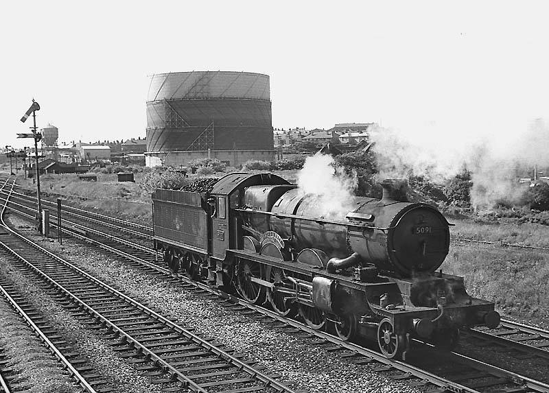Ex-GWR Castle Class 4-6-0 No 5091 'Cleeve Abbey' is seen reversing into Queens Head sidings ready to collect coaching stock on 29th June 1964 