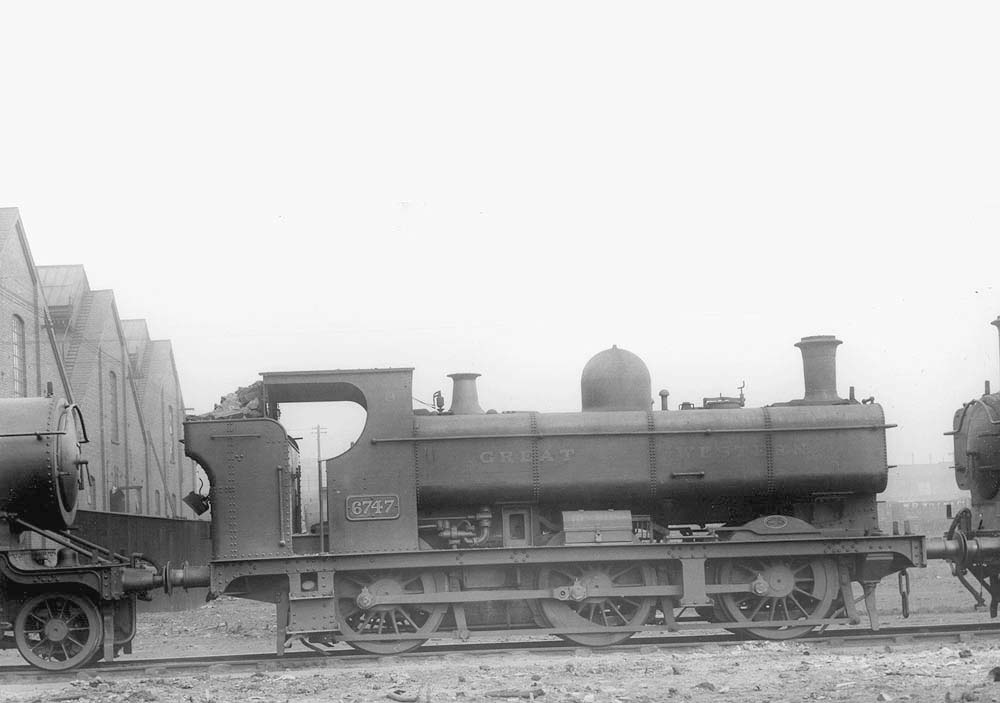 GWR 0-6-0PT No 6747, a 67xx class locomotive complete with full cab, is seen standing in line with other locomotives at Tyseley shed