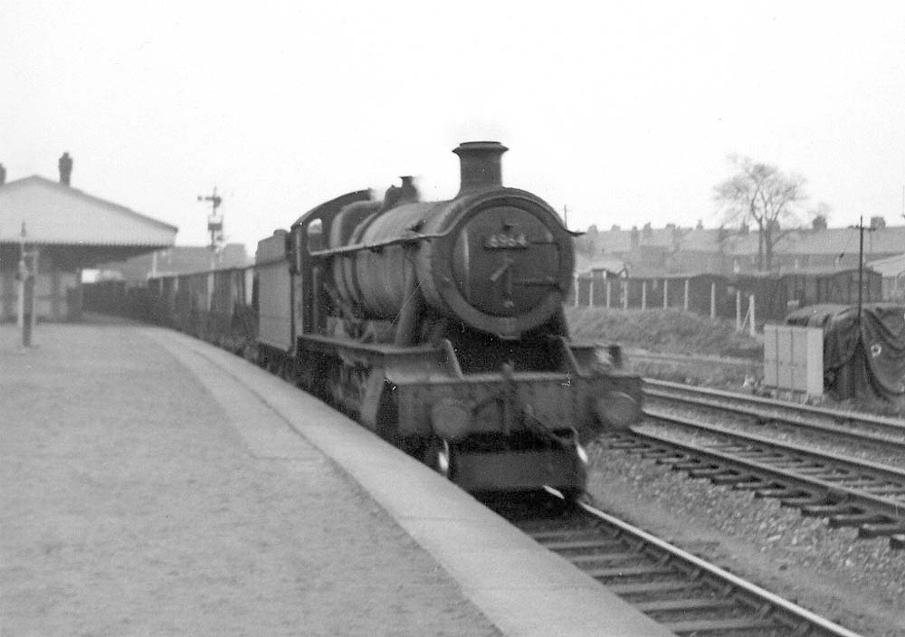 Ex-GWR 4-6-0 'Modified Hall' class No 6964 'Thornbridge Hall' is seen at the head of the 11:58am Banbury OIC to Bilston iron ore train on 15th February 1965