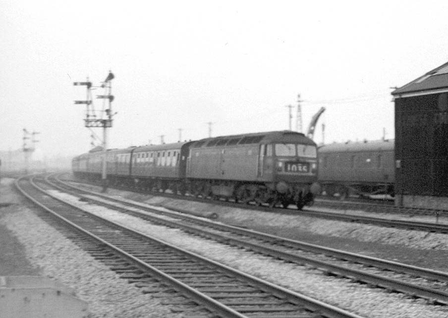 A Brush Type 4 Co-Co No D1755 is seen at the head of a southbound Pines Express service passing carriage sidings on 15th February 1965