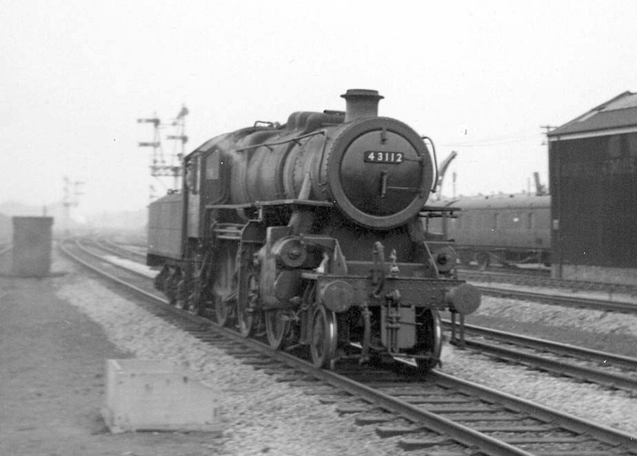 Ivatt 2-6-0 4MT No 43112 is seen running light engine past Tyesley carriage sidings and shed on 15th February 1965