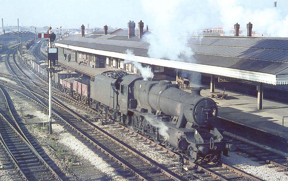 A very dirty ex-LMS 2-8-0 8F No 48385 has just restarted from signals as it heads an up London bound freight service on 6th November 1965