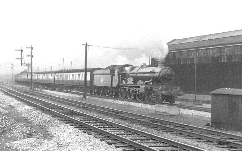 Ex-GWR 4-6-0 Castle class No 4079 'Pendennis Castle' is seen working hard as it passes Tyseley Goods shed at the head of an up express