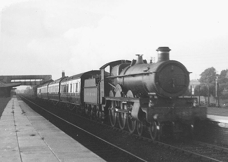 GWR 4-6-0 Saint class No 2927 'Saint Patrick' is seen passing through the station at speed on an up express