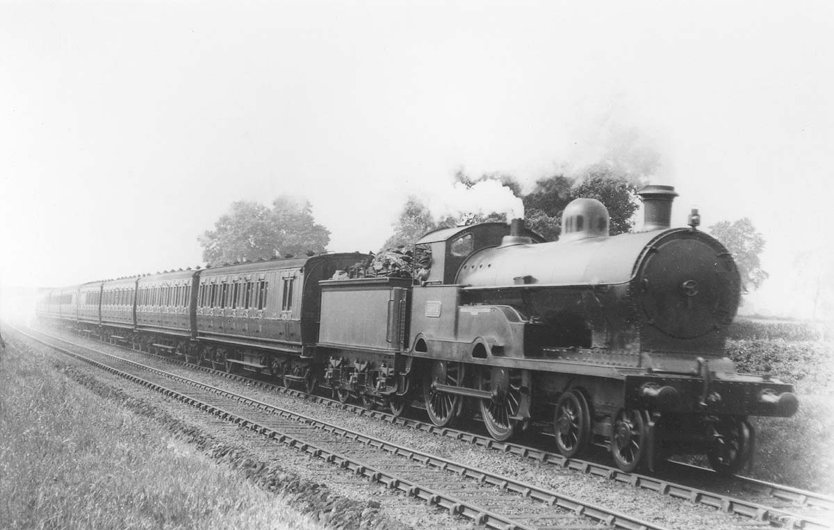 Ex-LNWR 4-4-0 George V No 1504 'Boarhound' class is seen at the head of an up express still in LNWR livery and prior to be renumbered No 5432 by the LMS