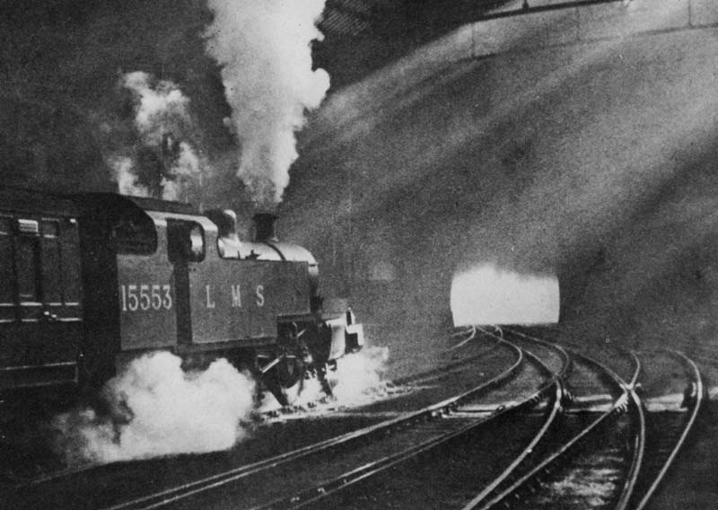 LMS 2-6-2T No 15553 is seen departing from the East end of Platform One's through line whilst at the head of an up local passenger service
