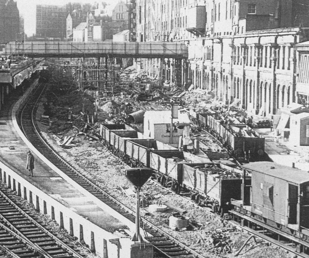 Close up showing the open 7-plank wagons standing on temporary track laid on the site of Platforms 1 to 3 on 22nd February 1966