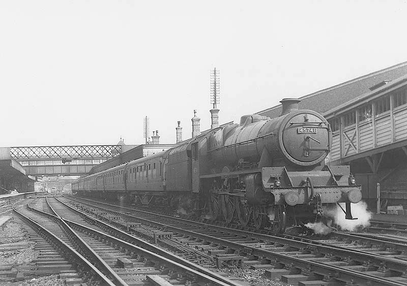 Ex-LMS 4-6-0 Jubilee class No 45741 'Leinster' stands at platform two with a down express train circa 1956