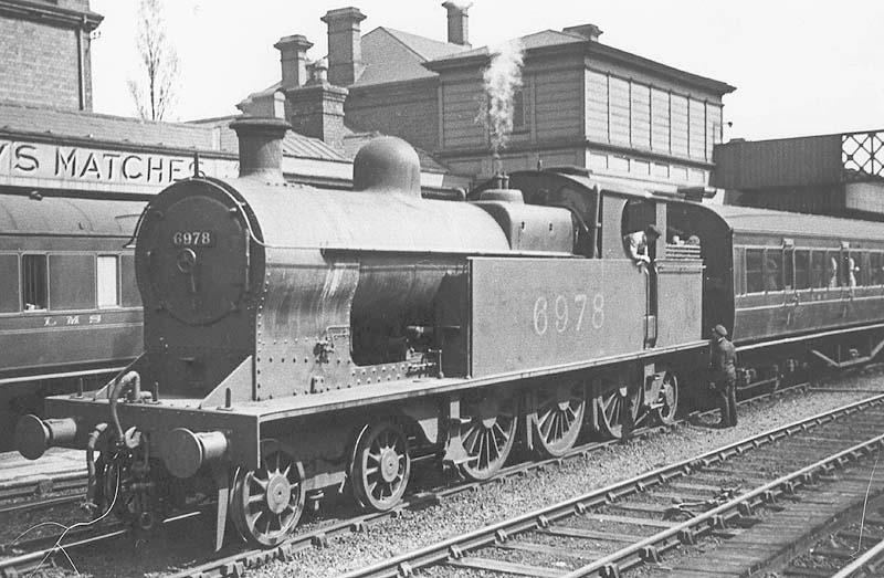 Ex-LNWR 4-6-2T 4P No 6978 is seen standing at the head of a local passenger service facing Birmingham but on the up line