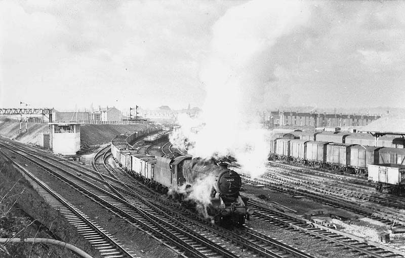 Ex-LMS 8F 2-8-0 No 48757 is seen leaving the Nuneaton branch with an up mineral train circa 1960