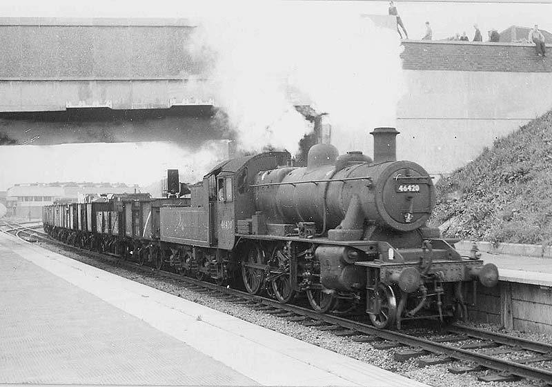 British Railways built 2MT 2-6-0 No 46420 enters Platform 4 as it heads a goods train coming off the Leamington branch