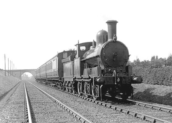 An unidentified LNWR 0-6-0 18" Goods Engine is seen working a local all stations passenger service near Hampton in Arden in July 1921