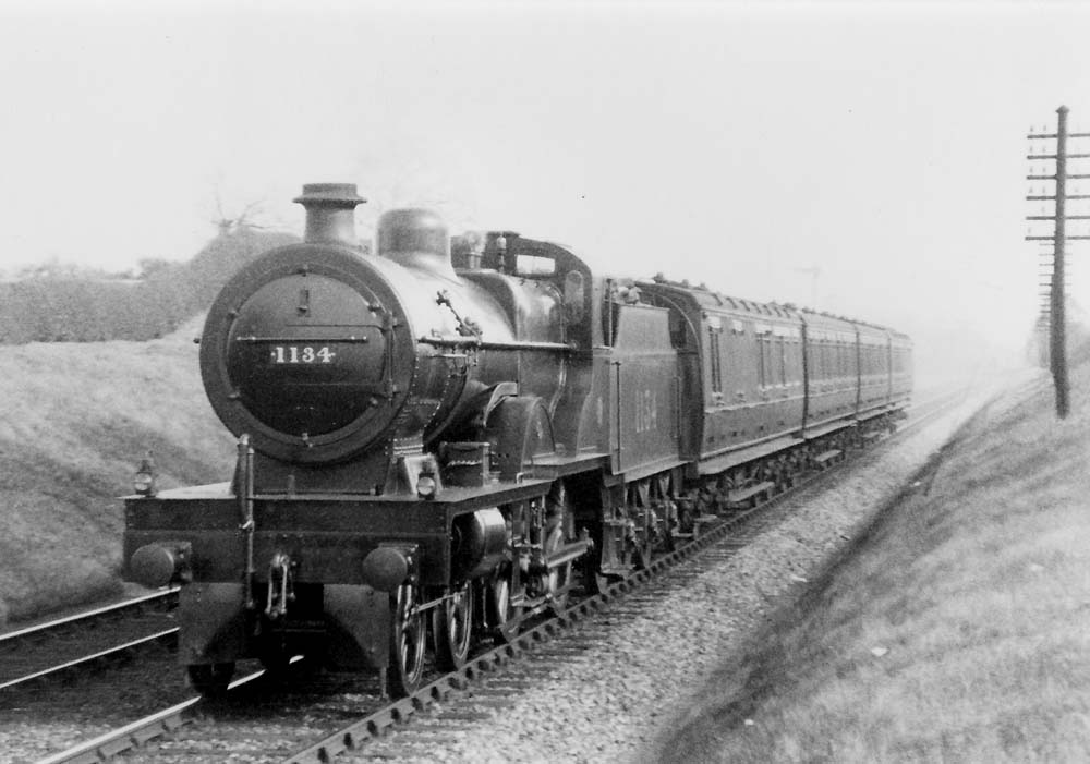 LMS 4P 4-4-0 Compound No 1134 is seen at the head of a down four-coach express train near Hampton in Arden in April 1927