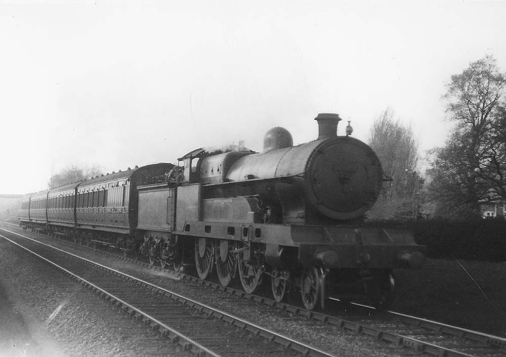Ex-LNWR 5XP 4-6-0 Claughton class No 6019 'Lewellyn' is seen near Hampton in Arden heading an up local passenger train to Rugby