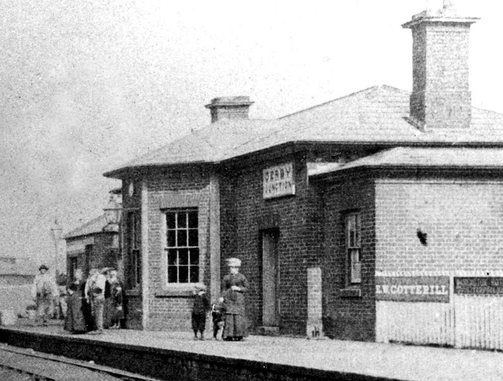 Close up showing the original B&DJR station building with the sign 'Derby Junction' displayed above the door to the station office and waiting room