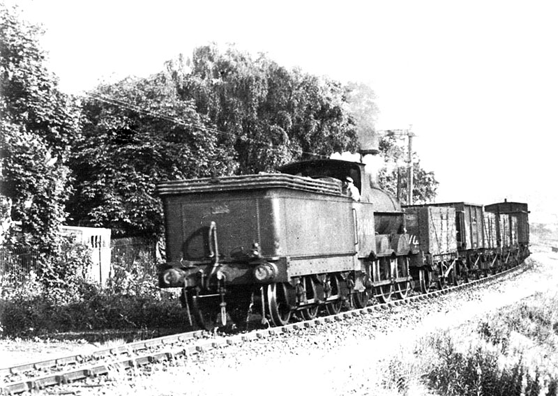 Ex-LNWR 2F 0-6-0 No 28616 is seen running tender first on a short pick up freight on 1st July 1949