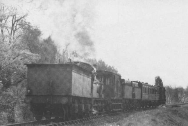 View of an unidentified 0-6-0 tender locomotive running tender first whilst in control of a weedkilling train