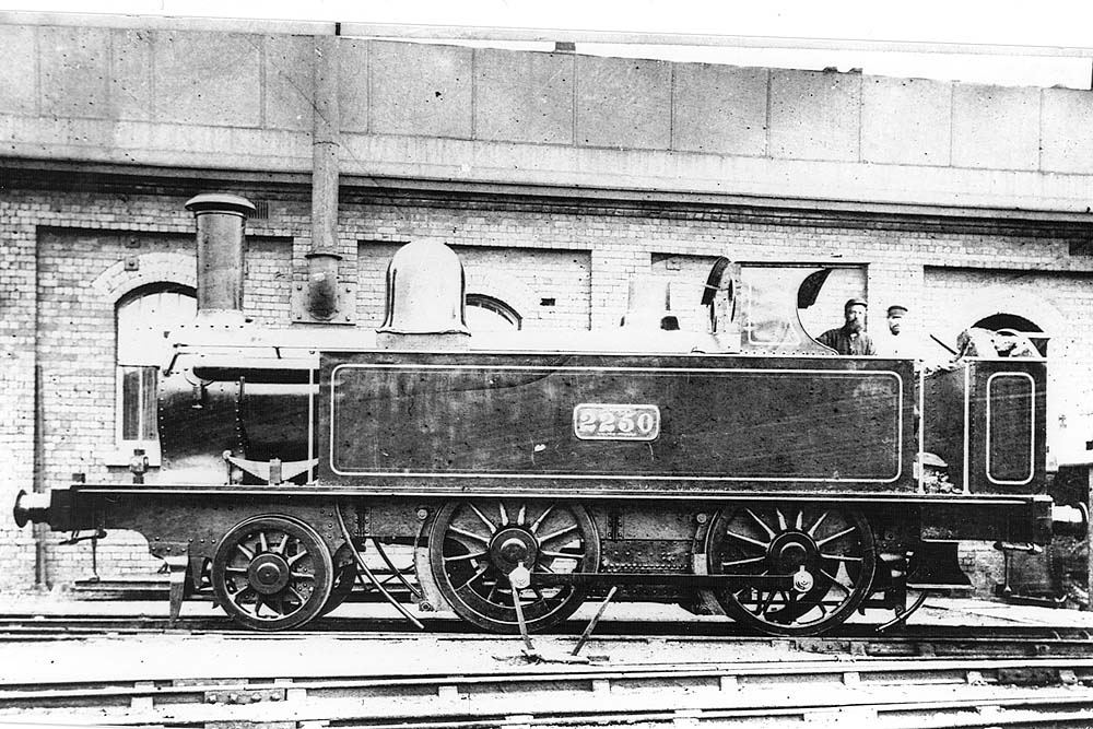 LNWR 2-4-0T 'half-cab' No 2250 is seen standing alongside Monument Lane shed's former coaling stage