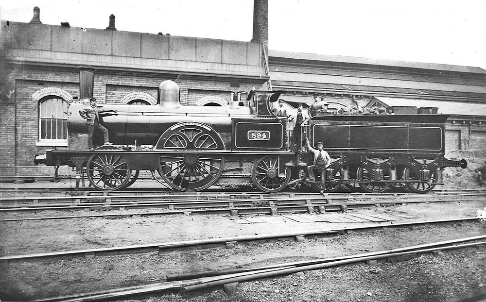 LNWR Large Bloomer 2-2-2 No 894 'Trentham' is posed yet again for the camera in front of the water tank and shed