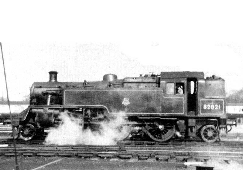 British Railways 2-6-2T Standard Class 3MT No 82021 is seen in steam coming off Nuneaton shed having been coaled and watered
