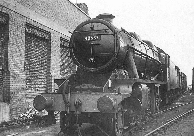 Ex-LMS 8F 2-8-0 No 48637 is seen stabled with others alongside the shed