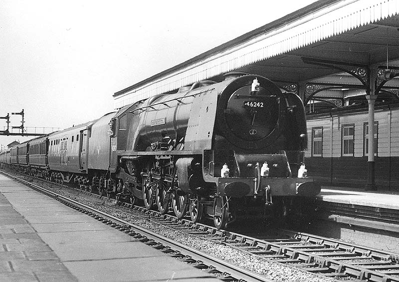 Ex-LMS 4-6-2 Coronation class No 46242 'City of Glasgow' is seen at the head of the Royal Train passing through Nuneaton station's platform four