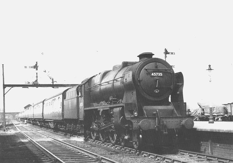 Ex-LMS 4-6-0 rebuilt Jubilee class No 45735 'Comet' is seen on an up express train as it passes through Nuneaton station's No 4 platform