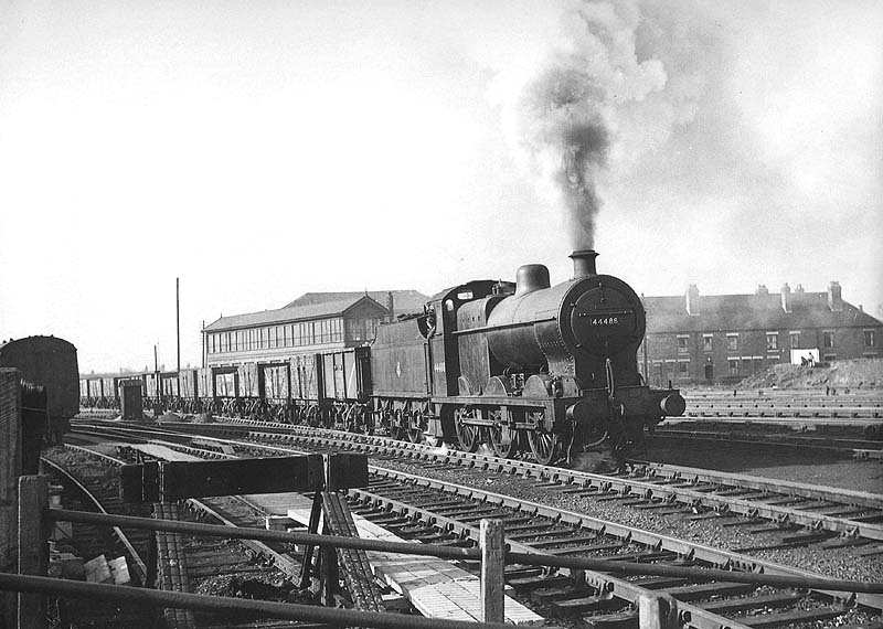 Ex-LMS 0-6-0 4F No 44488 is seen at the head of a mineral train crossing the Trent Valley line on to the Coventry branch