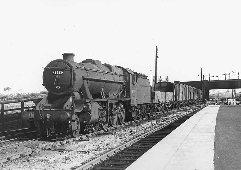 Ex-LMS 2-8-0 8F No 48723 is seen entering the throat to the up marshalling yards with a down Class K working
