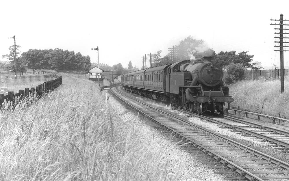 Ex-LMS 4MT 2-6-4T No 42674 is seen passing Perry Barr North Junction whilst at the head of a Walsall to New Street local passenger service