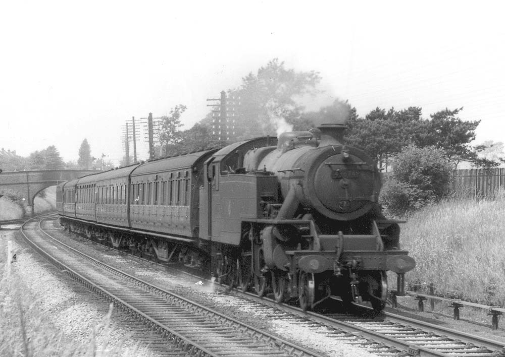 Close up of ex-LMS 4MT 2-6-4T No 42674, designed by Charles E Fairburn on a five coach local passenger train
