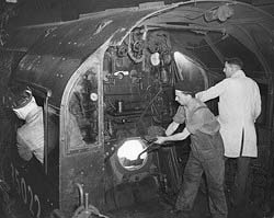 View of the crew working inside the cab of Bullied Pacific No 35022 'Holland America Line' in March 1953