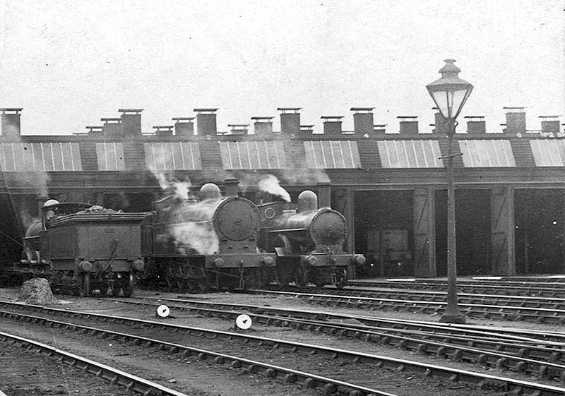 Close up showing an unidentified LNWR 0-6-0 locomotive in the company of an 0-8-0 and 2-4-0 locomotives