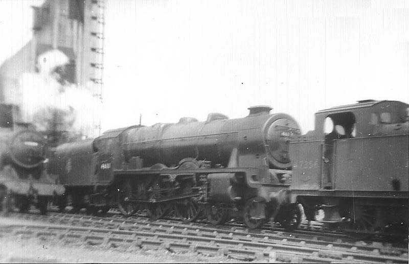 Ex-LMS 6P 4-6-0 No 46111 'Royal Fusilier' is seen being towed dead by ex-LMS 3F 0-6-0T 'Jinty' No 47356 in Spring 1959