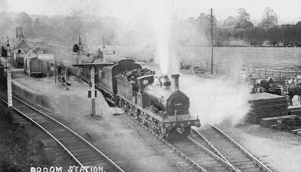 MR 2F 0-6-0 No 3460 with tender piled high blows steam off as it departs Broom Junction station