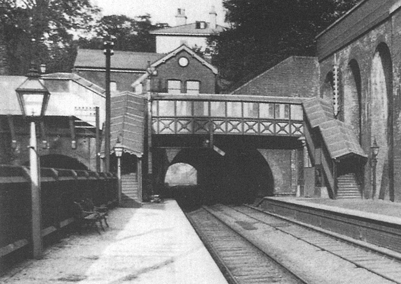 Close up showing Church Road tunnel and the lower quadrant signal suspended from beneath the passenger footbridge