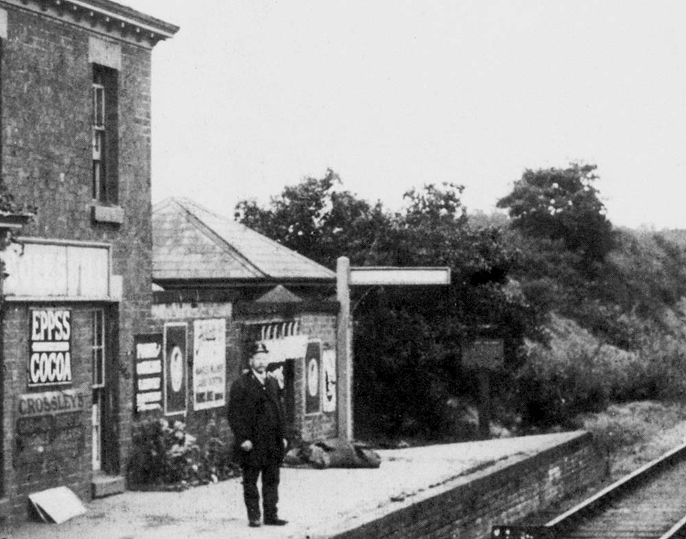 Close up showing the stationmaster posed on Coleshill station platform which has been raised to the height of the window sill