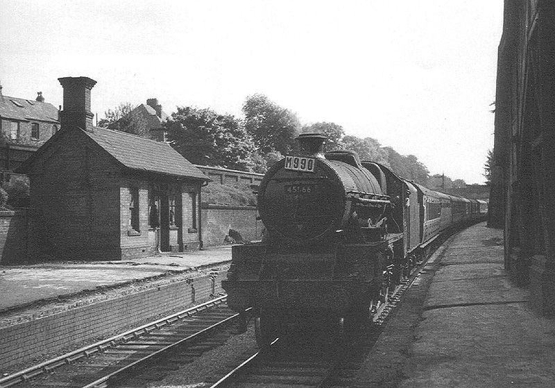 Ex-LMS 4-6-0 5XP No 45566 'Queensland' is seen passing the now abandoned Five Ways station at the head of an up train to New Street on 24th May 1953