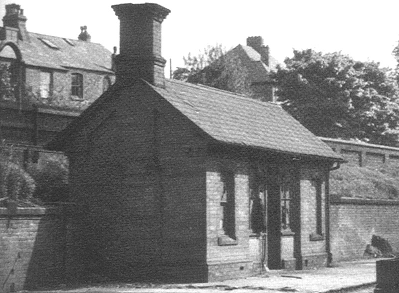 Close up showing the small brick waiting room erected on Five Ways station's down platform