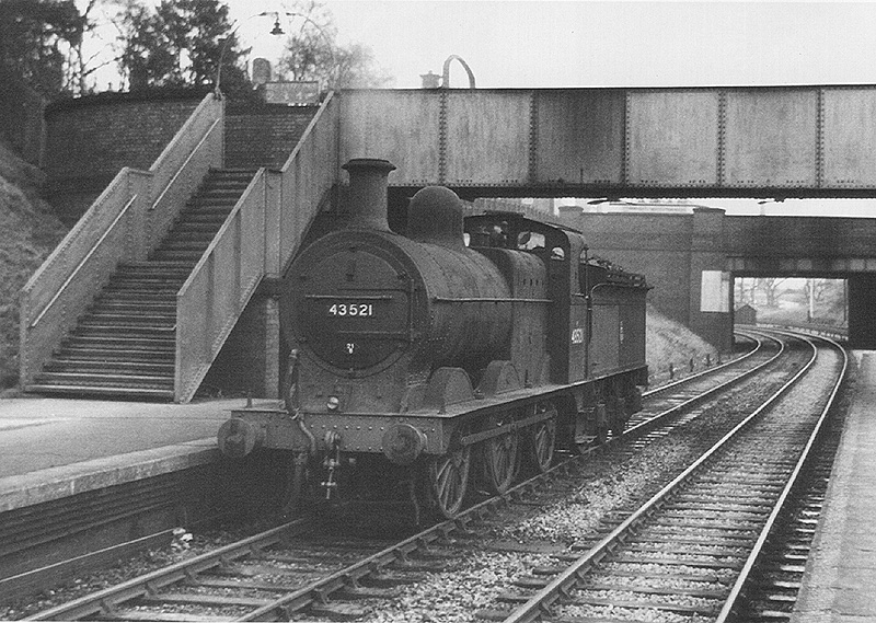 Ex-MR 0-6-0 3F No 43521 stands at rest at the West Suburban Railway up platform at Kings Norton on 28th December 1954